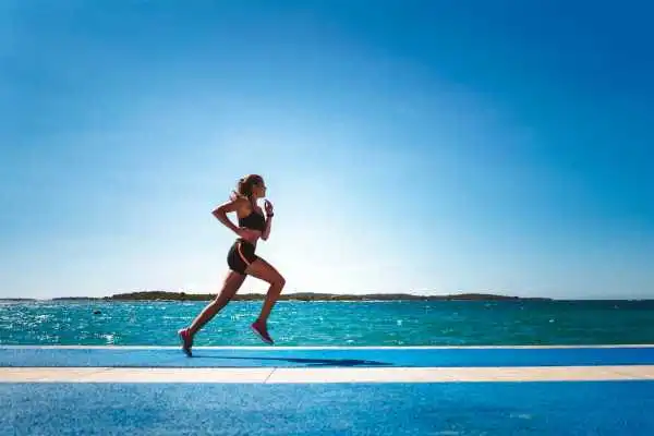 Woman running showing strong leg muscle Wokingham